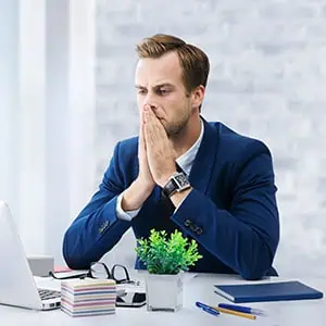 A man sits at his desk, looking stressed - Darryl A. Stallworth Law Office